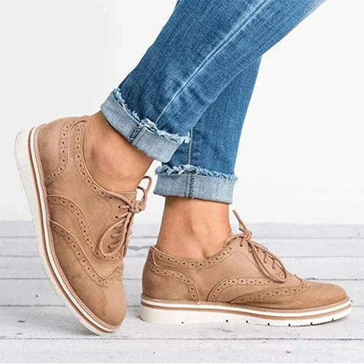 Image showing women's classic sneakers with a stylish brogue design, featuring lace-up closure and a comfortable sole, perfect for casual wear.