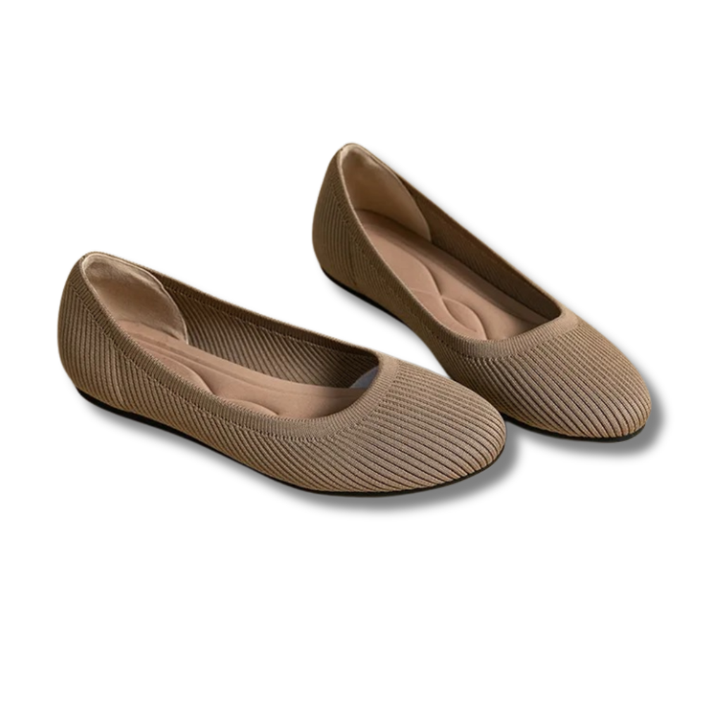 A pair of women's comfortable flat shoes designed with a ribbed texture and cushioned insoles, perfect for everyday wear.