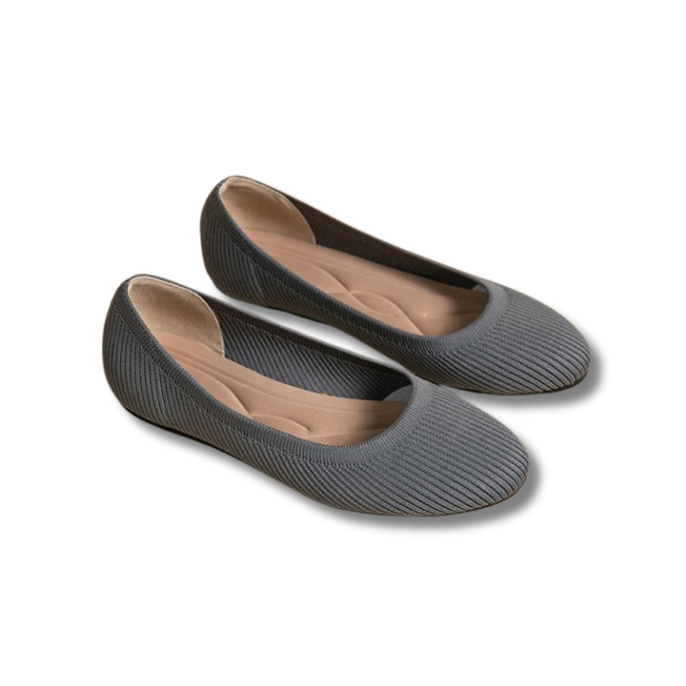 A pair of women's comfortable flat shoes designed with a ribbed texture and cushioned insoles, perfect for everyday wear.