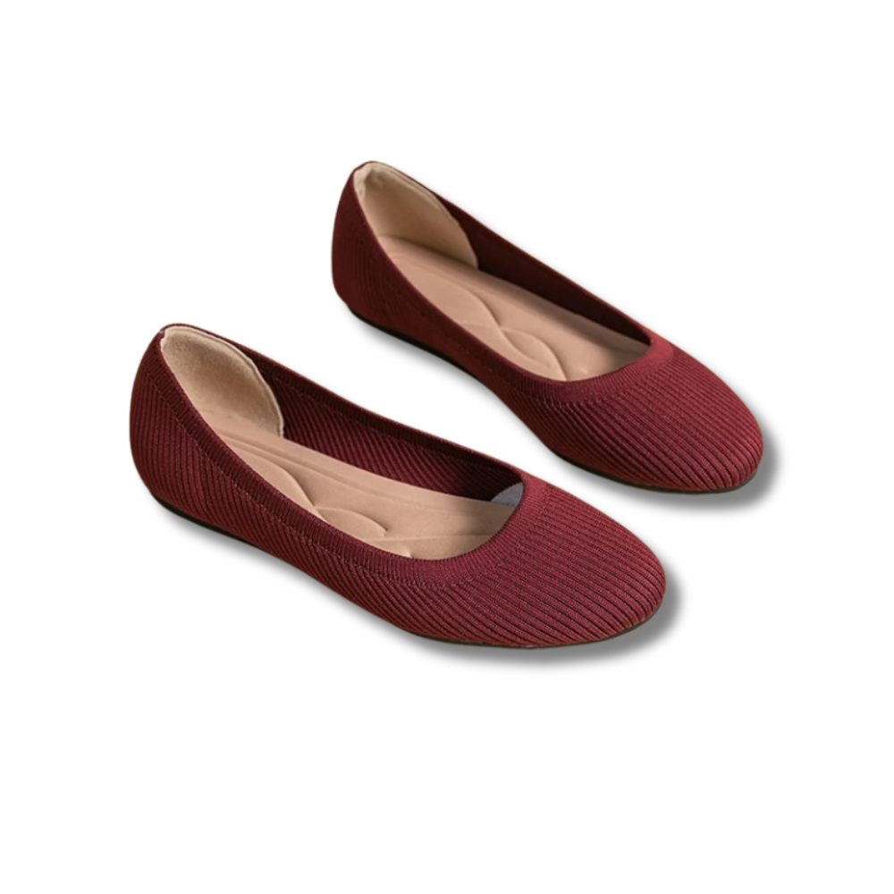A pair of women's comfortable flat shoes designed with a ribbed texture and cushioned insoles, perfect for everyday wear.