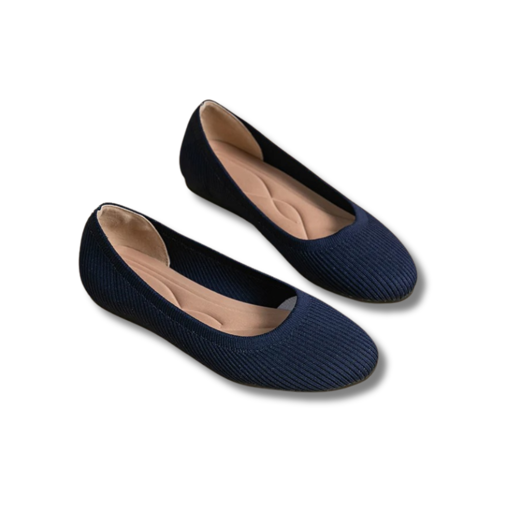 A pair of women's comfortable flat shoes designed with a ribbed texture and cushioned insoles, perfect for everyday wear.