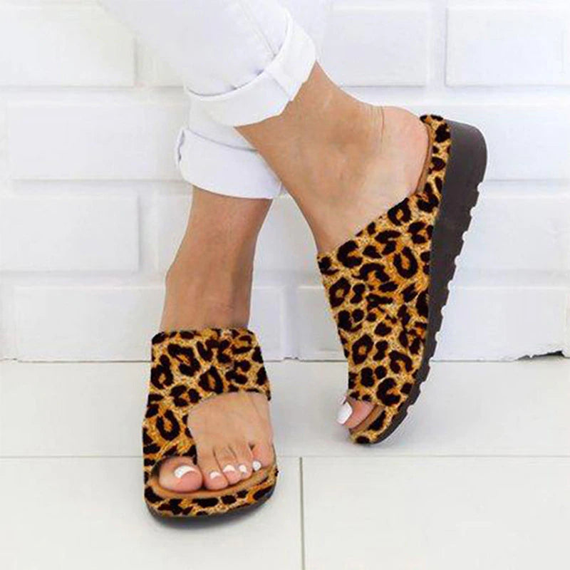 Stylish women's sandals with a comfortable fit, designed for casual wear and summer outings, paired with white pants for a chic look.