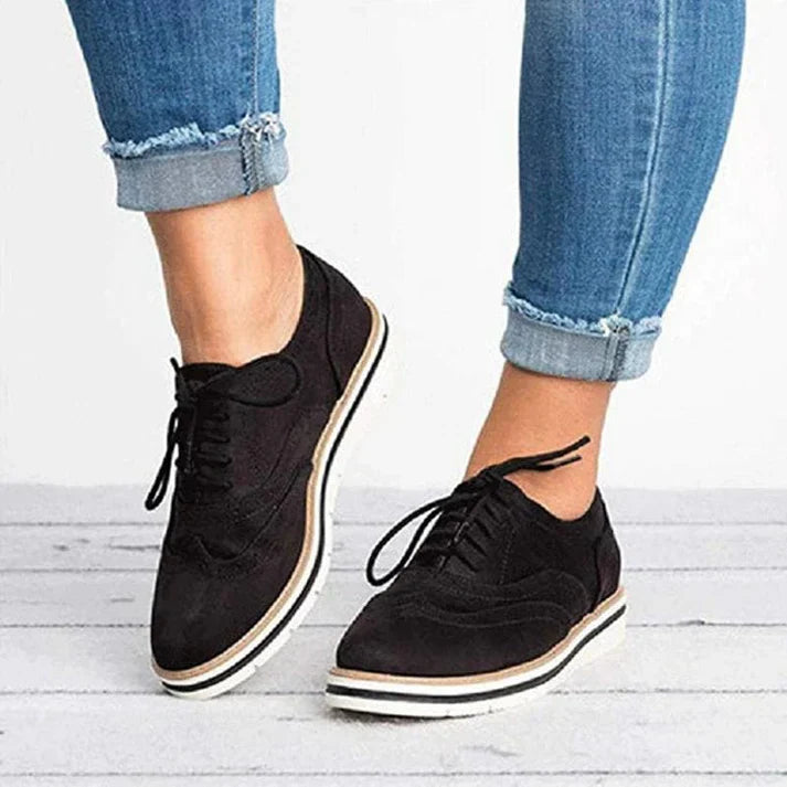 Image showing women's classic sneakers with a stylish brogue design, featuring lace-up closure and a comfortable sole, perfect for casual wear.