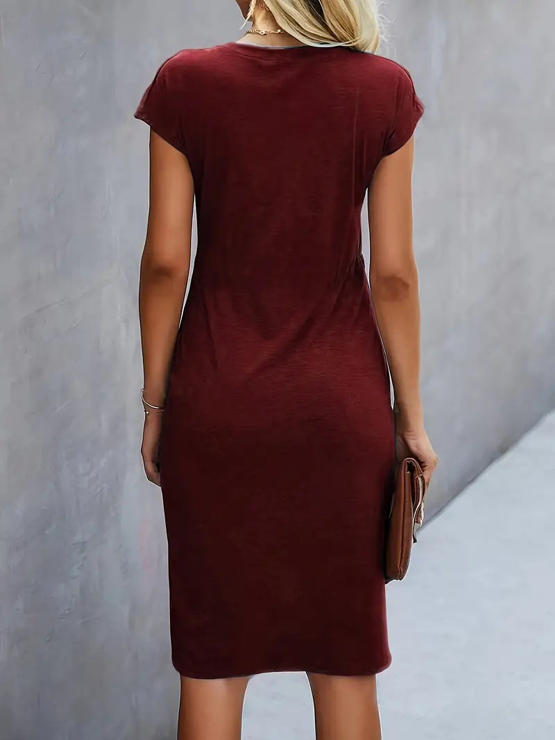 A woman wearing an elegant dress with a flattering ruched design, perfect for both casual outings and formal events. The dress highlights a sophisticated and stylish silhouette, paired with a clutch for a polished look.