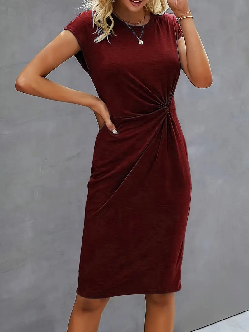 A woman wearing an elegant dress with a flattering ruched design, perfect for both casual outings and formal events. The dress highlights a sophisticated and stylish silhouette, paired with a clutch for a polished look.