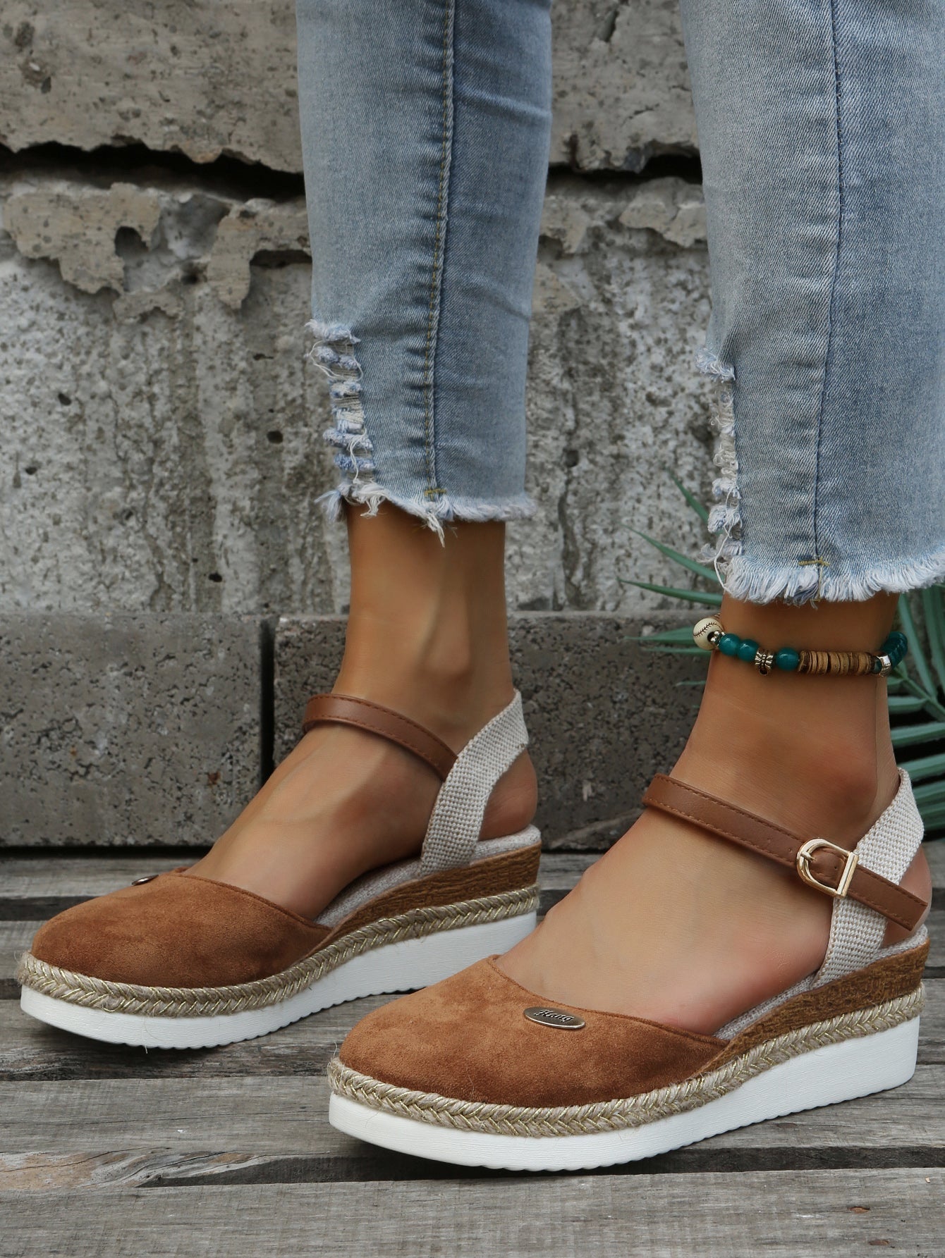 An image showcasing stylish women's wedge sandals with a comfortable design, featuring adjustable ankle straps and a supportive sole, perfect for casual or semi-formal outings.
