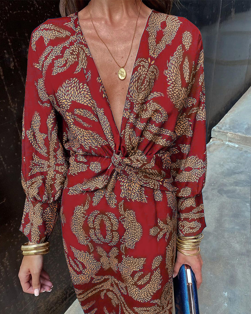 A close-up of a woman wearing the Nina Women's Elegant Wrap Dress, featuring a bold pattern and flattering wrap design with a deep V-neckline. The dress showcases intricate patterns and a knot detail at the waist, creating a sophisticated and stylish look suitable for special occasions.