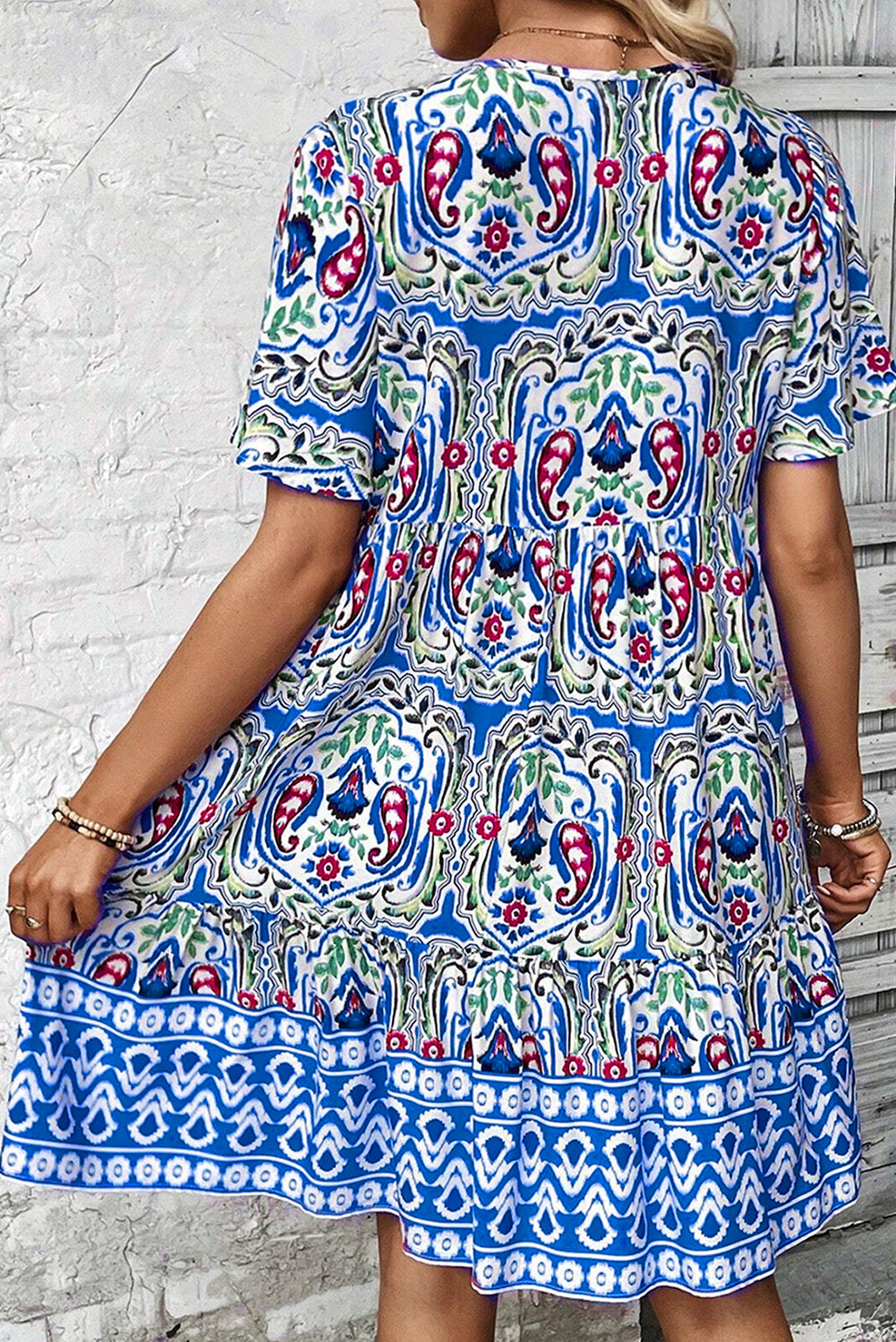 Model wearing the Sienna Women's Boho Print Dress, showcasing a relaxed fit and intricate bohemian-inspired patterns. The dress features a deep V-neckline, short sleeves, and a flowy, casual design ideal for warm-weather outings.