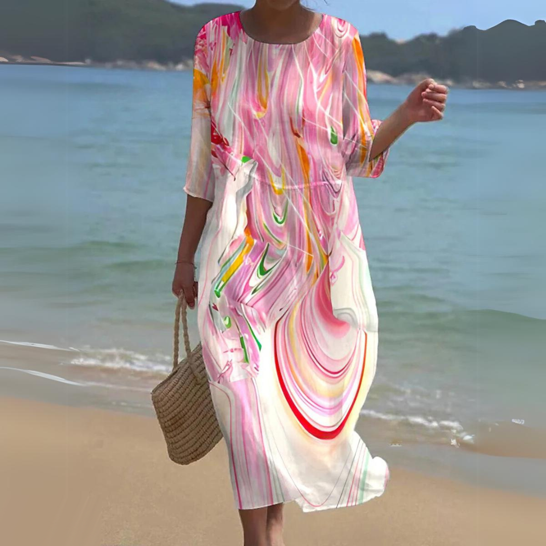 Elegant women's floral dress worn on the beach, paired with a woven handbag, perfect for summer outings and casual strolls.