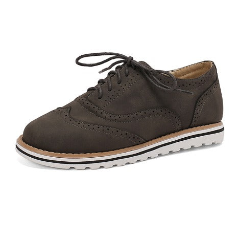 Image showing women's classic sneakers with a stylish brogue design, featuring lace-up closure and a comfortable sole, perfect for casual wear.