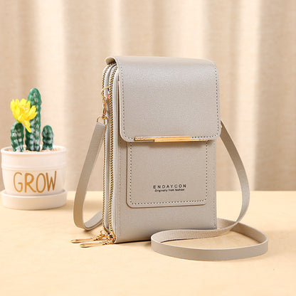 Image showing a compact and stylish women's crossbody bag with a sleek design, featuring a front flap, zipper closure, and an adjustable strap, ideal for carrying essentials on the go.