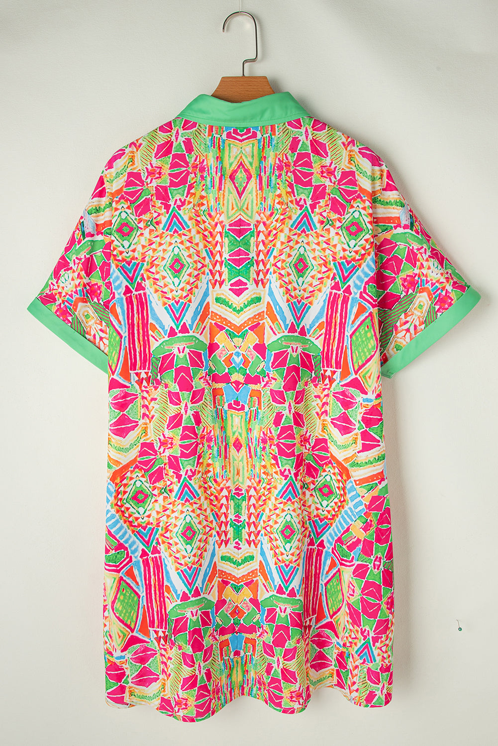 Woman wearing the Zara Women's Geometric Button-Down Dress with a vibrant pattern, accessorized with a handbag and bold jewelry. The dress features a relaxed fit and geometric design, perfect for a stylish and casual look.