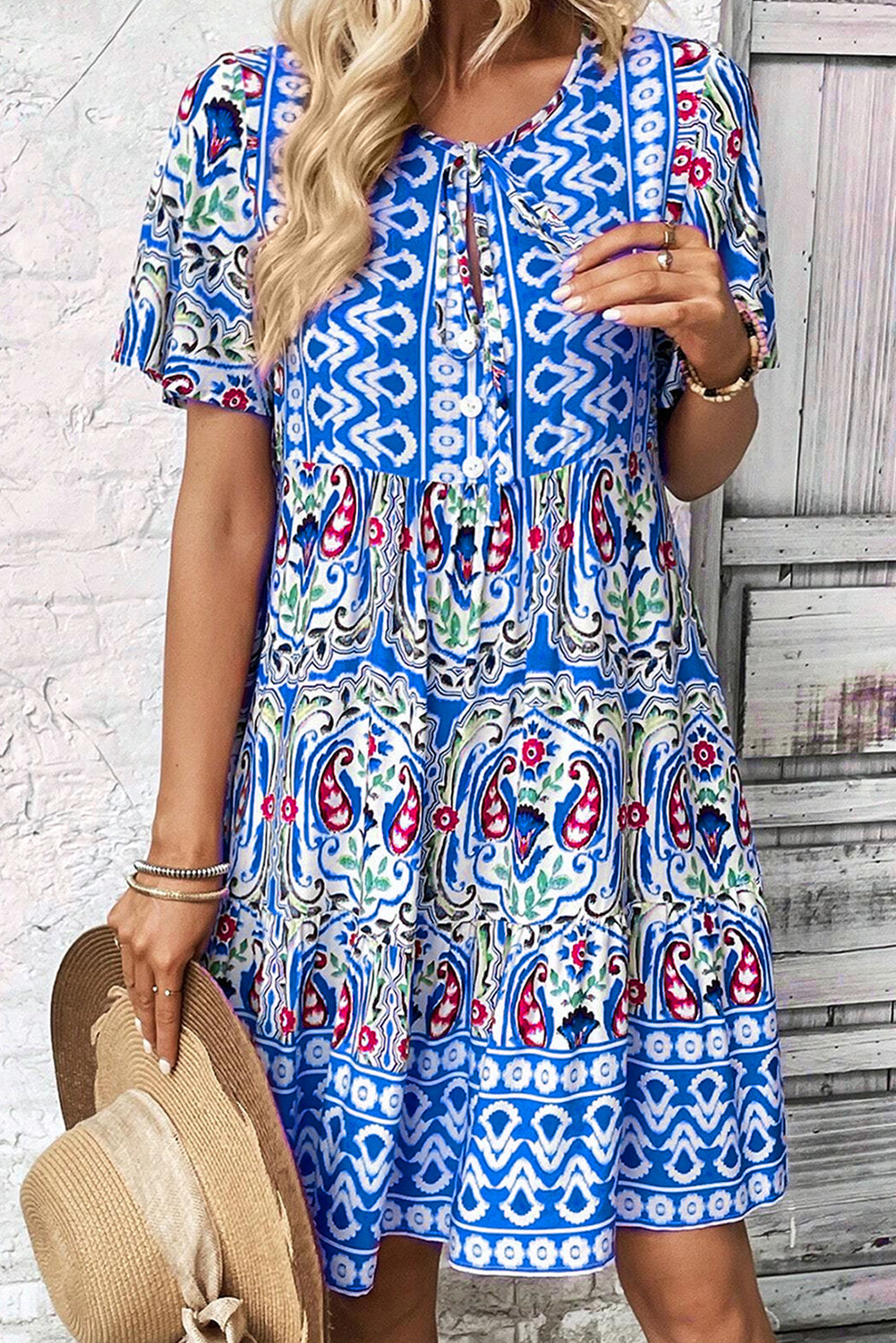Model wearing the Sienna Women's Boho Print Dress, showcasing a relaxed fit and intricate bohemian-inspired patterns. The dress features a deep V-neckline, short sleeves, and a flowy, casual design ideal for warm-weather outings.