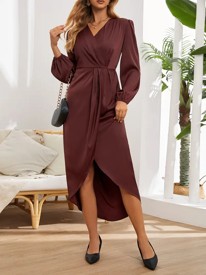 A woman wearing a long wrap dress with elegant long sleeves, walking confidently on a city street. The dress features a flattering wrap design that cinches at the waist, creating a graceful silhouette perfect for both formal and casual occasions. She carries a stylish handbag to complete the look.