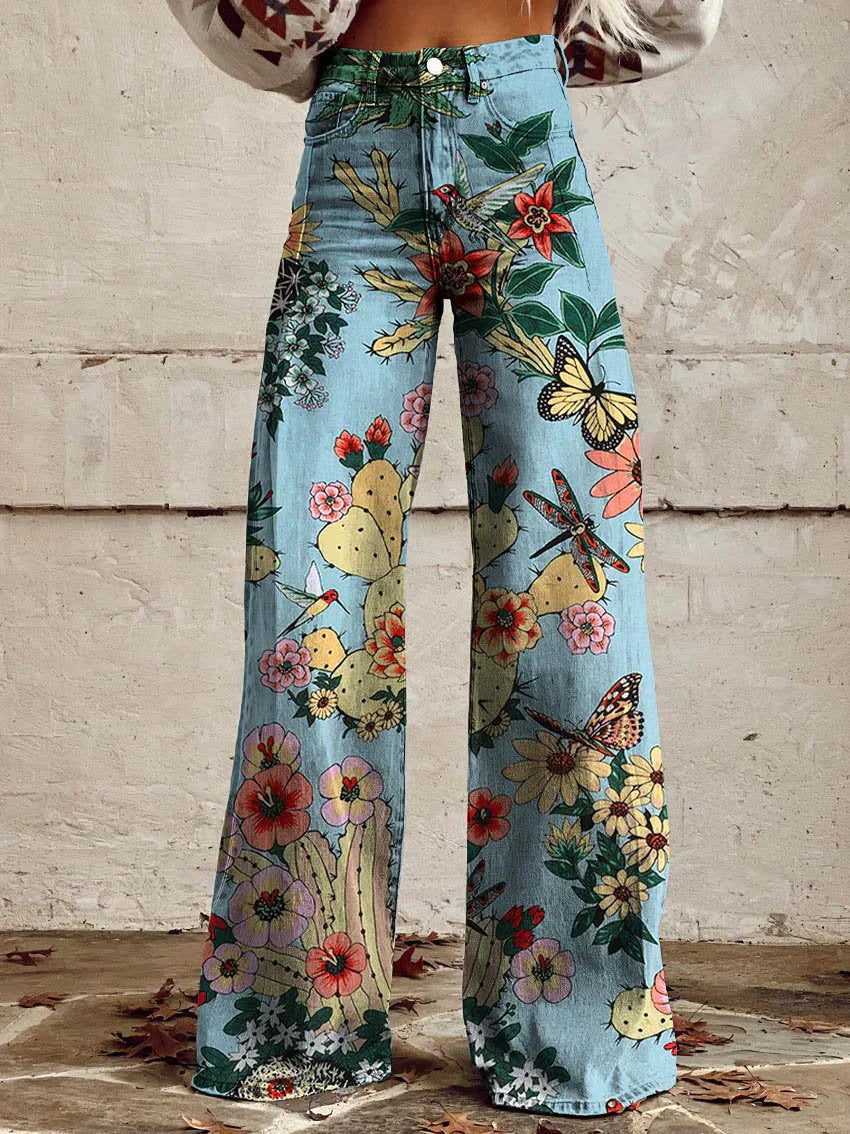 A pair of Jasmine Women's Boho Wide-Leg Pants featuring a bold floral print with nature-inspired patterns, including flowers and butterflies. These wide-leg pants have a relaxed fit, perfect for adding a boho touch to any casual or festival outfit.