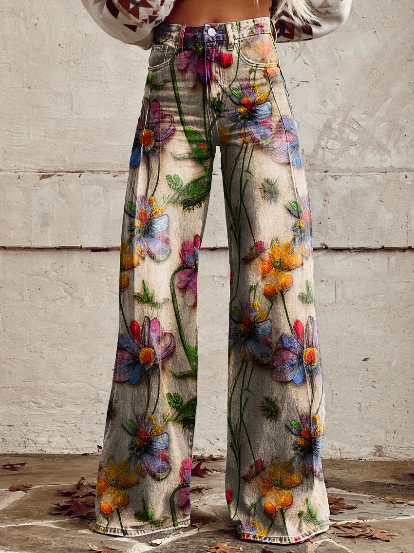 A pair of Jasmine Women's Boho Wide-Leg Pants featuring a bold floral print with nature-inspired patterns, including flowers and butterflies. These wide-leg pants have a relaxed fit, perfect for adding a boho touch to any casual or festival outfit.