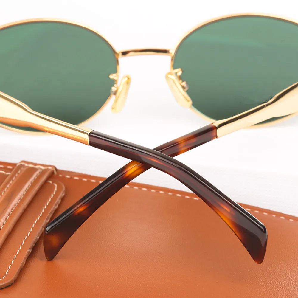 A pair of elegant women's sunglasses with a chic oval frame and stylish detailing, perfect for enhancing any outfit and providing essential UV protection. Designed for a lightweight and comfortable fit, ideal for daily wear or special occasions.
