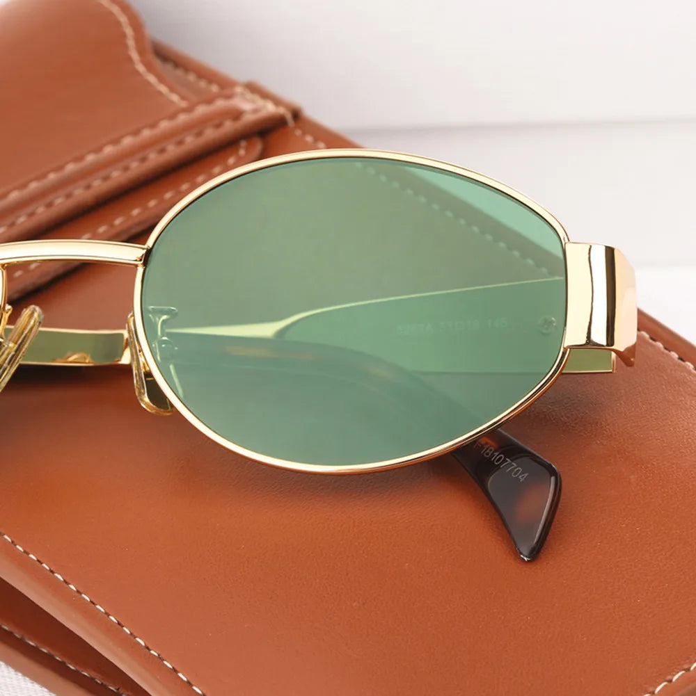 A pair of elegant women's sunglasses with a chic oval frame and stylish detailing, perfect for enhancing any outfit and providing essential UV protection. Designed for a lightweight and comfortable fit, ideal for daily wear or special occasions.