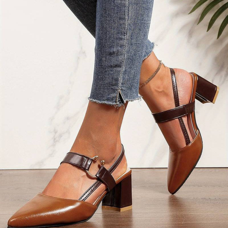A pair of Sophia Women's Elegant Block Heel Shoes with a stylish double-strap design and pointed toe, worn by a person. These heels feature a comfortable block heel, perfect for adding elegance to both casual and formal outfits.