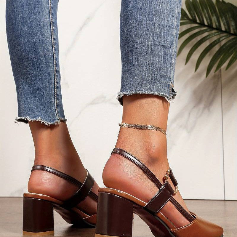 A pair of Sophia Women's Elegant Block Heel Shoes with a stylish double-strap design and pointed toe, worn by a person. These heels feature a comfortable block heel, perfect for adding elegance to both casual and formal outfits.
