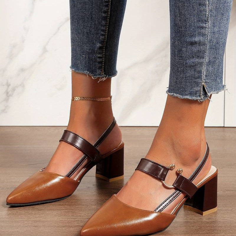 A pair of Sophia Women's Elegant Block Heel Shoes with a stylish double-strap design and pointed toe, worn by a person. These heels feature a comfortable block heel, perfect for adding elegance to both casual and formal outfits.