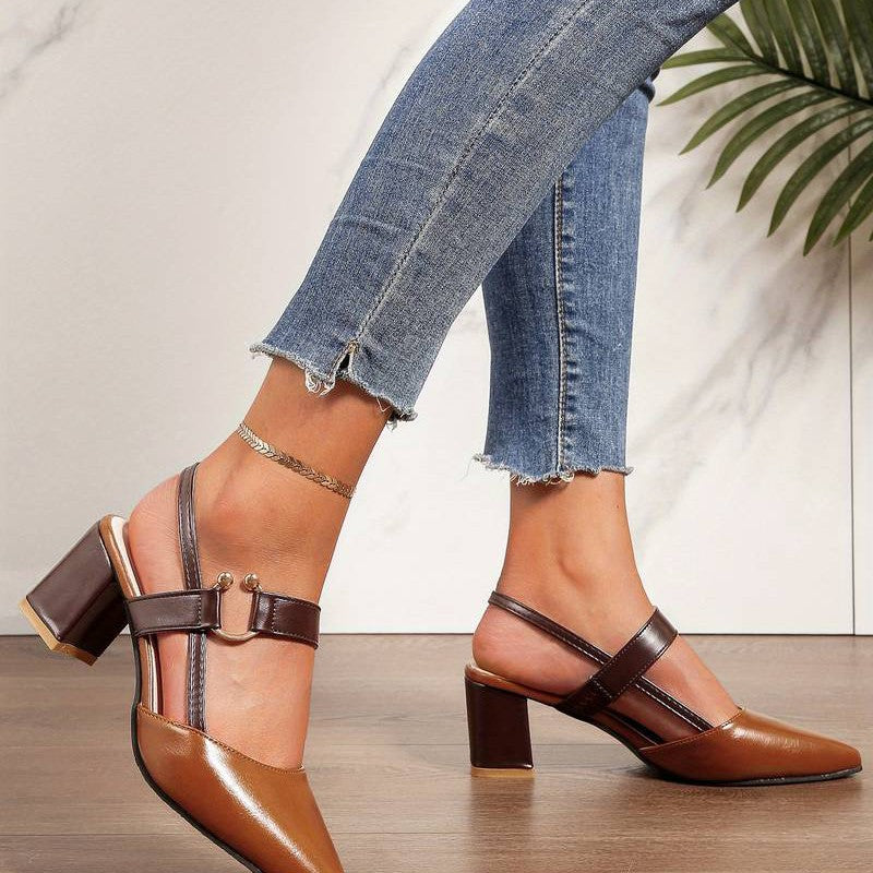 A pair of Sophia Women's Elegant Block Heel Shoes with a stylish double-strap design and pointed toe, worn by a person. These heels feature a comfortable block heel, perfect for adding elegance to both casual and formal outfits.
