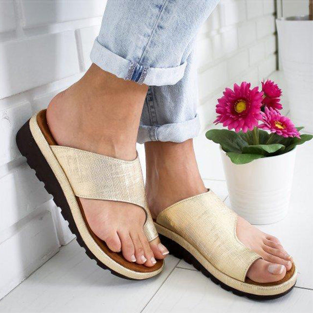 Stylish women's sandals with a comfortable fit, designed for casual wear and summer outings, paired with white pants for a chic look.