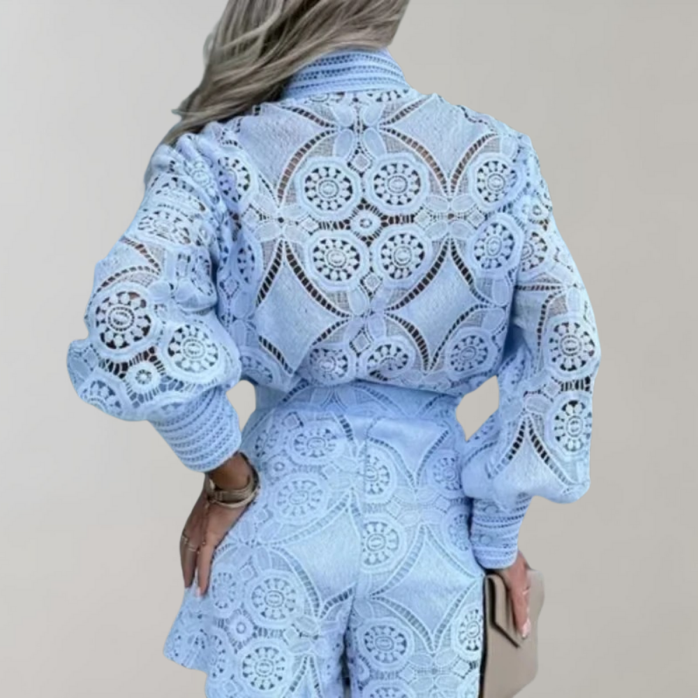 Women's elegant lace dress featuring intricate detailing, long sleeves, a fitted waist, and a flared skirt for a chic and sophisticated look.