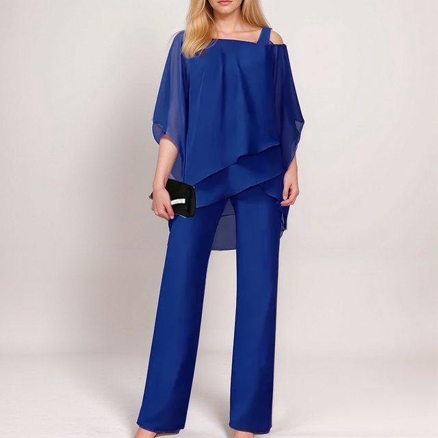 A stylish woman wearing the Sophia | Women's Layered Jumpsuit | Elegant Jumpsuit, featuring a flowing layered top and tailored wide-leg pants, accessorized with a clutch bag and heels, perfect for formal or special occasions.