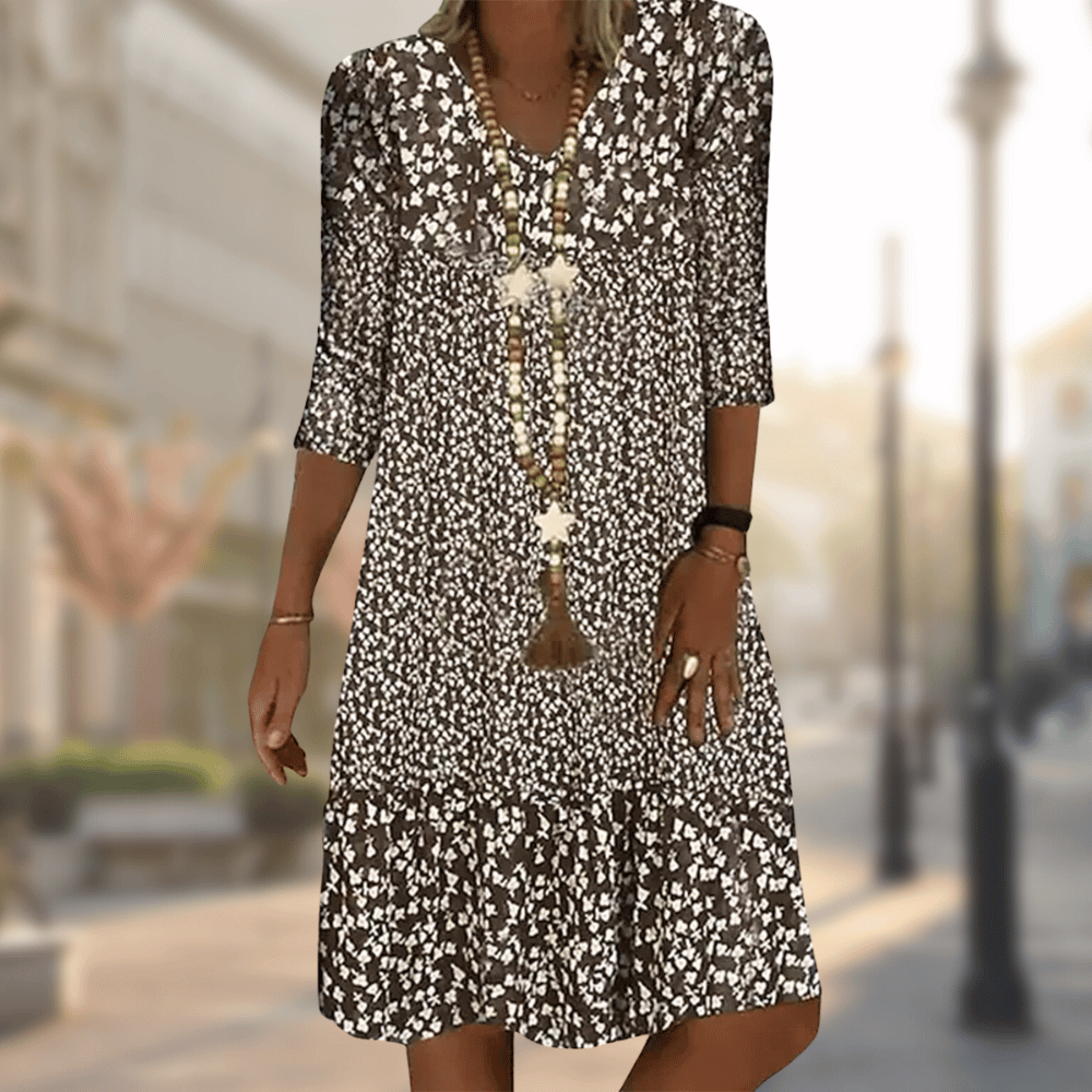 A woman wearing the Lila Women's Floral Midi Dress, featuring a boho chic style with a floral pattern and relaxed fit. The dress has three-quarter sleeves and a flowing silhouette, perfect for casual outings or beach-inspired looks.