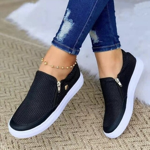 Stylish women's slip-on shoes with a breathable design, paired with casual jeans and an anklet, perfect for everyday comfort and fashion.