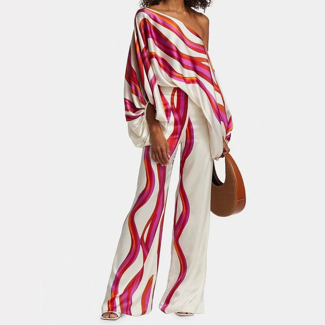 Women's summer jumpsuit with a flowing, one-shoulder design featuring vibrant patterns. Perfect for casual outings, beach days, or evening events, combining elegance and comfort for a chic summer look.