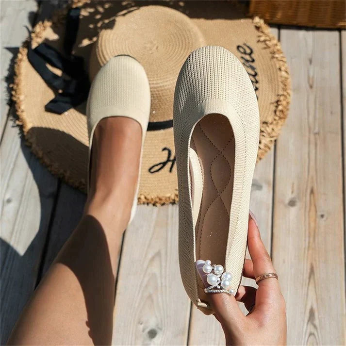 A pair of Lily Women's Stylish Comfort Shoes, designed as slip-on shoes with a textured fabric finish and cushioned insole, held by a person showcasing the lightweight and comfortable design ideal for everyday wear.