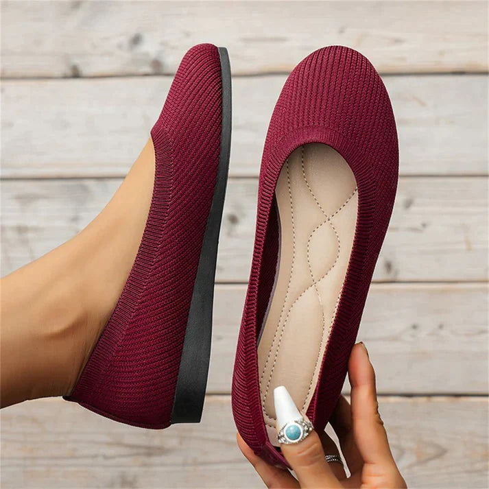 A pair of Lily Women's Stylish Comfort Shoes, designed as slip-on shoes with a textured fabric finish and cushioned insole, held by a person showcasing the lightweight and comfortable design ideal for everyday wear.