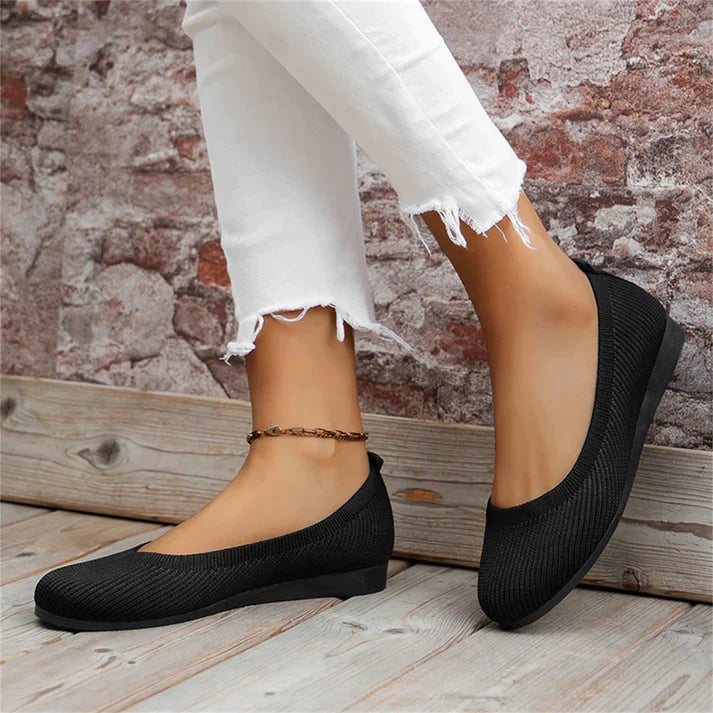 A pair of Lily Women's Stylish Comfort Shoes, designed as slip-on shoes with a textured fabric finish and cushioned insole, held by a person showcasing the lightweight and comfortable design ideal for everyday wear.