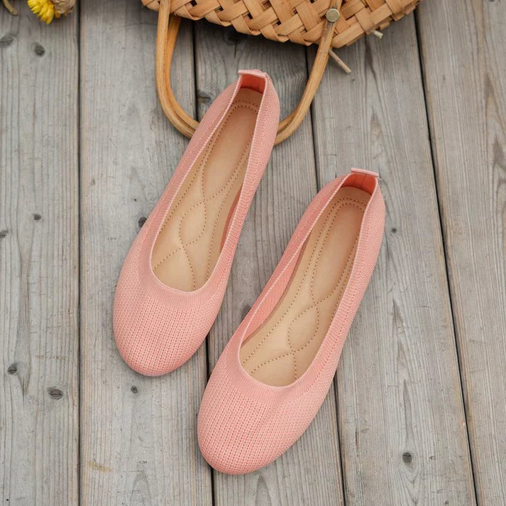 A pair of Lily Women's Stylish Comfort Shoes, designed as slip-on shoes with a textured fabric finish and cushioned insole, held by a person showcasing the lightweight and comfortable design ideal for everyday wear.