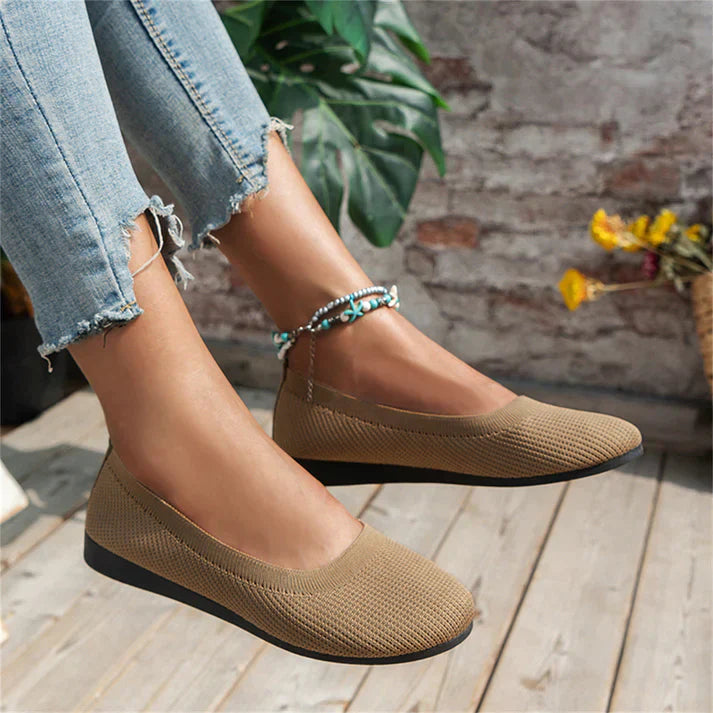 A pair of Lily Women's Stylish Comfort Shoes, designed as slip-on shoes with a textured fabric finish and cushioned insole, held by a person showcasing the lightweight and comfortable design ideal for everyday wear.