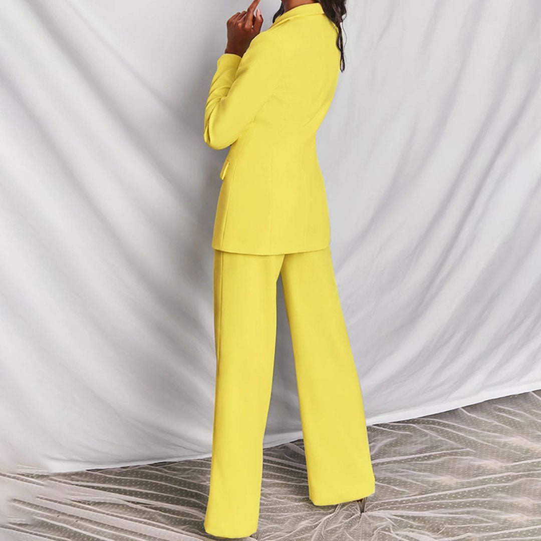 Model wearing the Victoria | Tailored Wide-Leg Blazer Set, featuring a sharp, structured blazer paired with elegant wide-leg pants. This chic set offers a sophisticated and powerful look, perfect for formal events or business occasions.