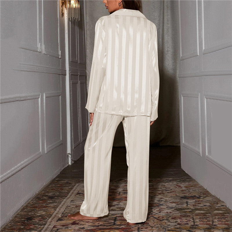 A woman wearing a luxurious satin pajama set featuring a button-up shirt and relaxed-fit pants, perfect for comfortable and elegant loungewear or sleepwear. Ideal for cozy nights or stylish relaxation at home.