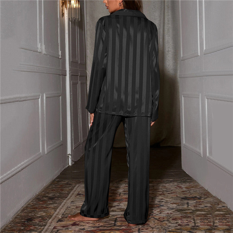 A woman wearing a luxurious satin pajama set featuring a button-up shirt and relaxed-fit pants, perfect for comfortable and elegant loungewear or sleepwear. Ideal for cozy nights or stylish relaxation at home.