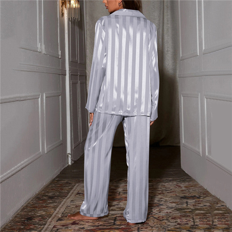 A woman wearing a luxurious satin pajama set featuring a button-up shirt and relaxed-fit pants, perfect for comfortable and elegant loungewear or sleepwear. Ideal for cozy nights or stylish relaxation at home.