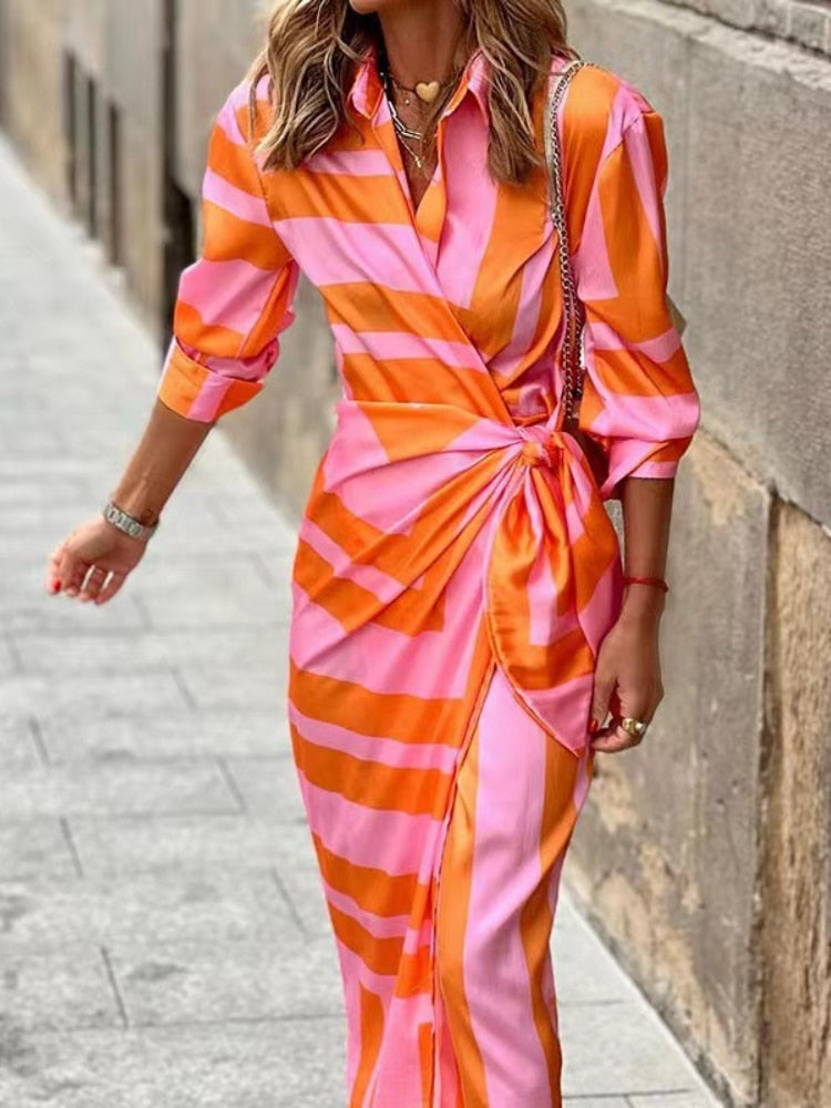 A stylish wrap dress with a striped pattern, featuring a fitted design and tied waist detail, perfect for casual or formal occasions, showcasing elegance and sophistication.