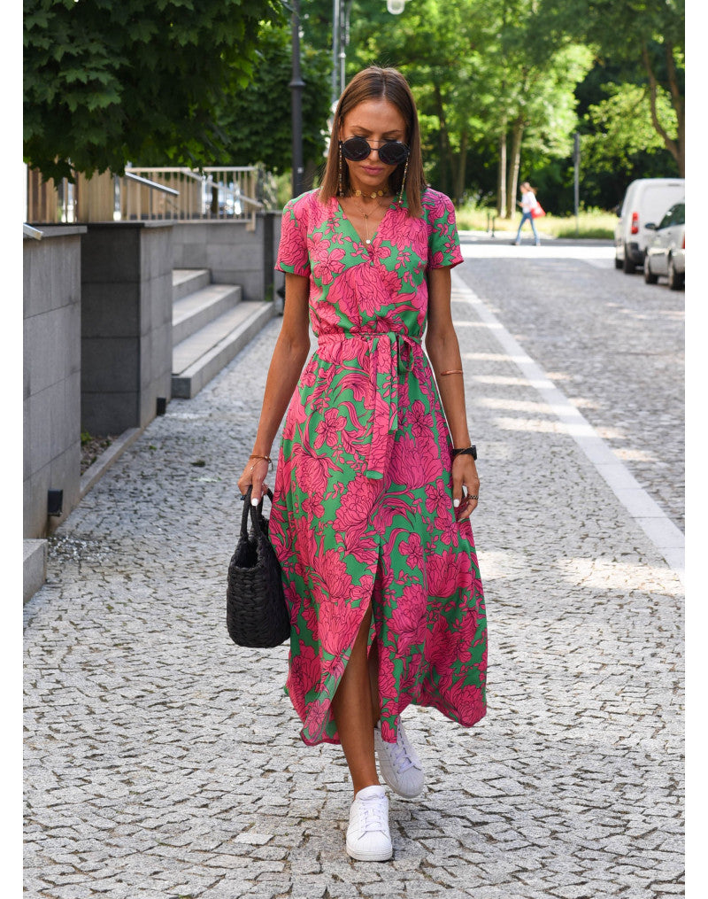 A woman walking down a street wearing the Lana Women's Elegant Wrap Dress, a casual midi dress with a flattering wrap design and tie waist, styled with sneakers and a woven handbag. This versatile dress is ideal for both casual outings and stylish gatherings.