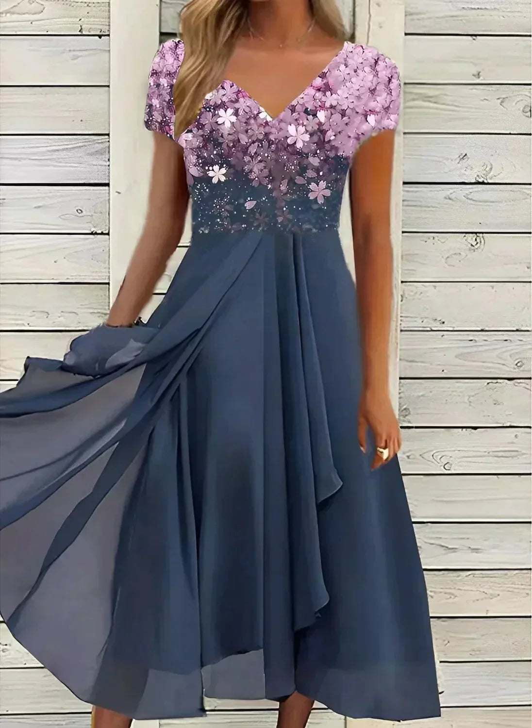 A woman wearing the Sienna Women's Sparkling Evening Dress, featuring a dazzling, sparkling bodice and a flowing midi-length skirt. This elegant dress is designed for formal events and special occasions, offering a graceful and glamorous look.