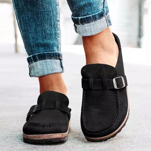 Women's stylish loafers with a comfortable design, featuring a slip-on style and elegant buckle detail, paired with rolled-up denim jeans for a casual look.
