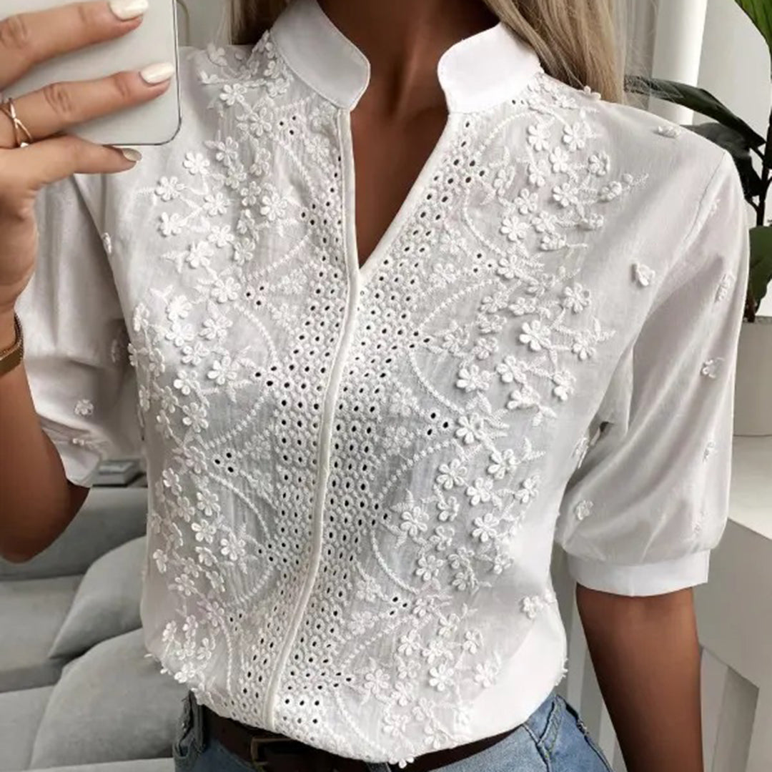 Model wearing the Elise | Embroidered Button-Up Blouse, featuring intricate floral embroidery and a polished button-up design. This elegant blouse is perfect for both casual and formal occasions, adding a touch of sophistication to any outfit.