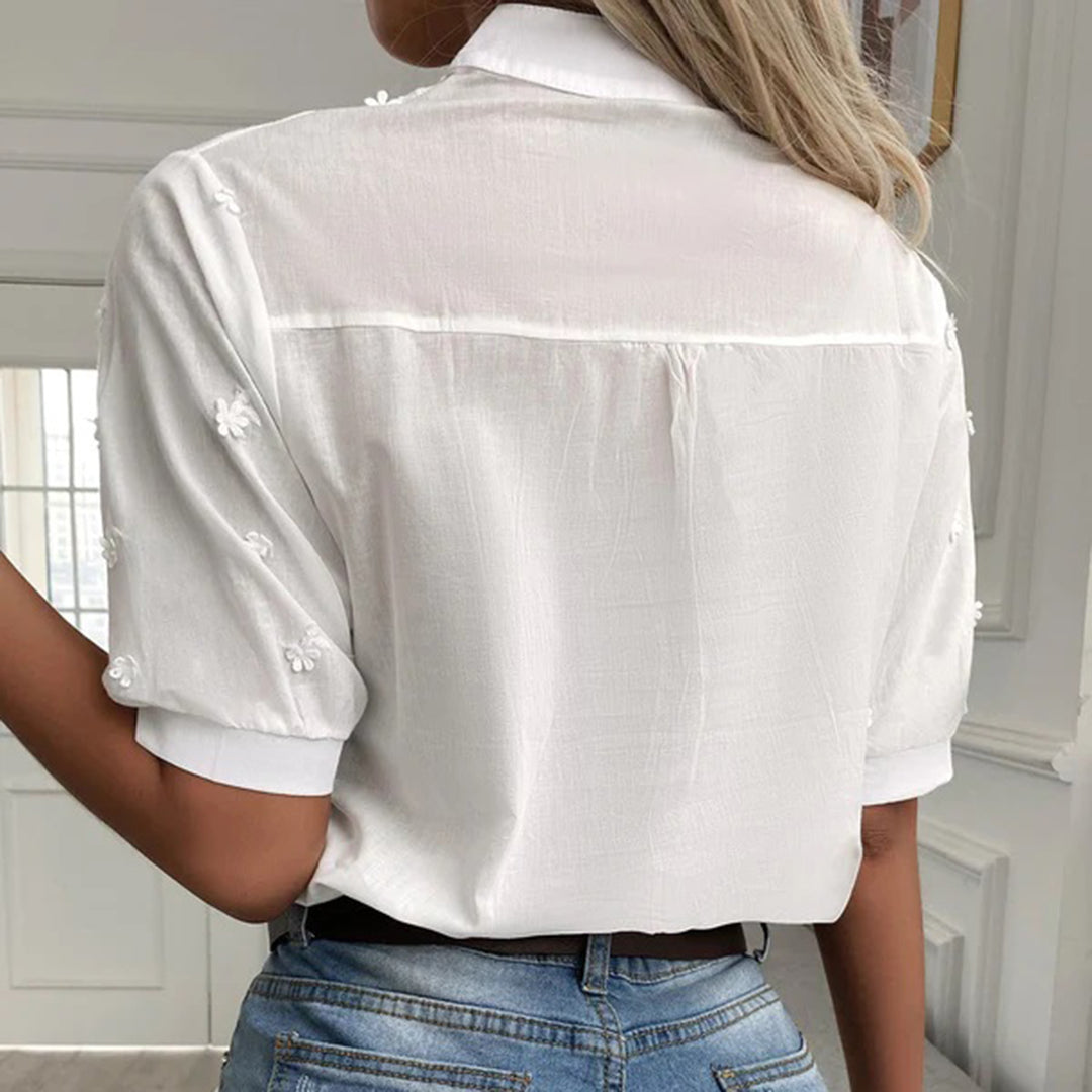 Model wearing the Elise | Embroidered Button-Up Blouse, featuring intricate floral embroidery and a polished button-up design. This elegant blouse is perfect for both casual and formal occasions, adding a touch of sophistication to any outfit.