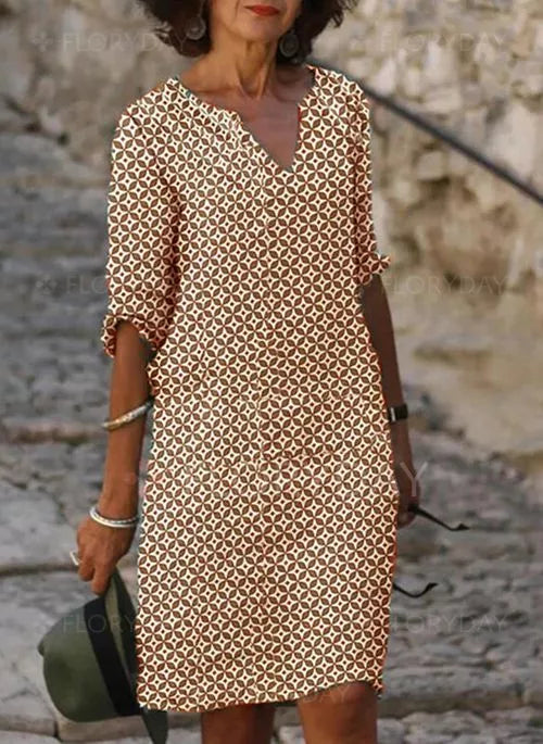 Woman wearing a patterned dress with a relaxed fit, featuring a stylish and comfortable design ideal for casual outings.