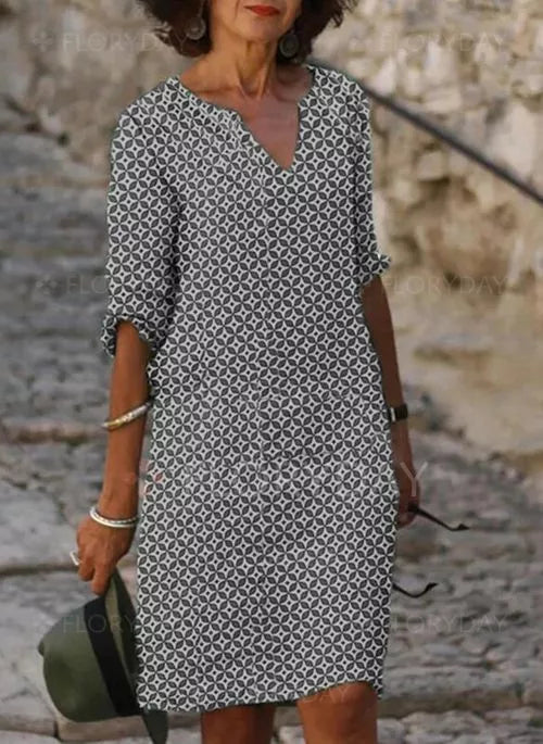 Woman wearing a patterned dress with a relaxed fit, featuring a stylish and comfortable design ideal for casual outings.