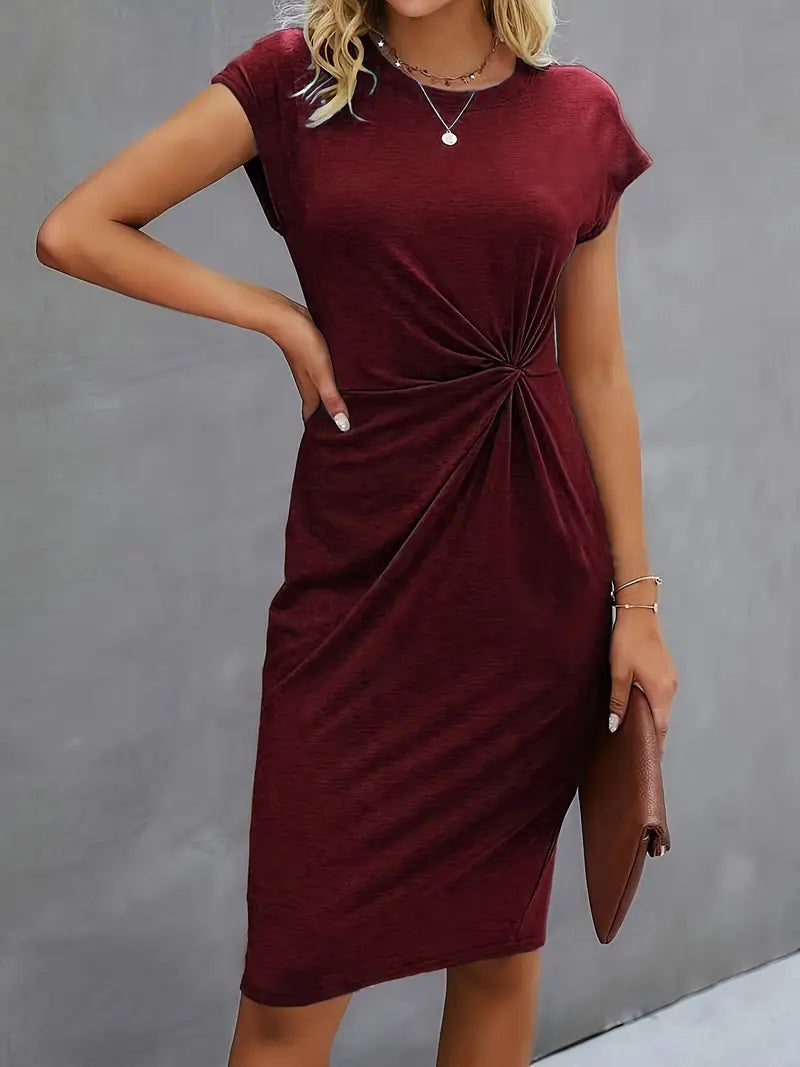 A woman wearing an elegant dress with a flattering ruched design, perfect for both casual outings and formal events. The dress highlights a sophisticated and stylish silhouette, paired with a clutch for a polished look.